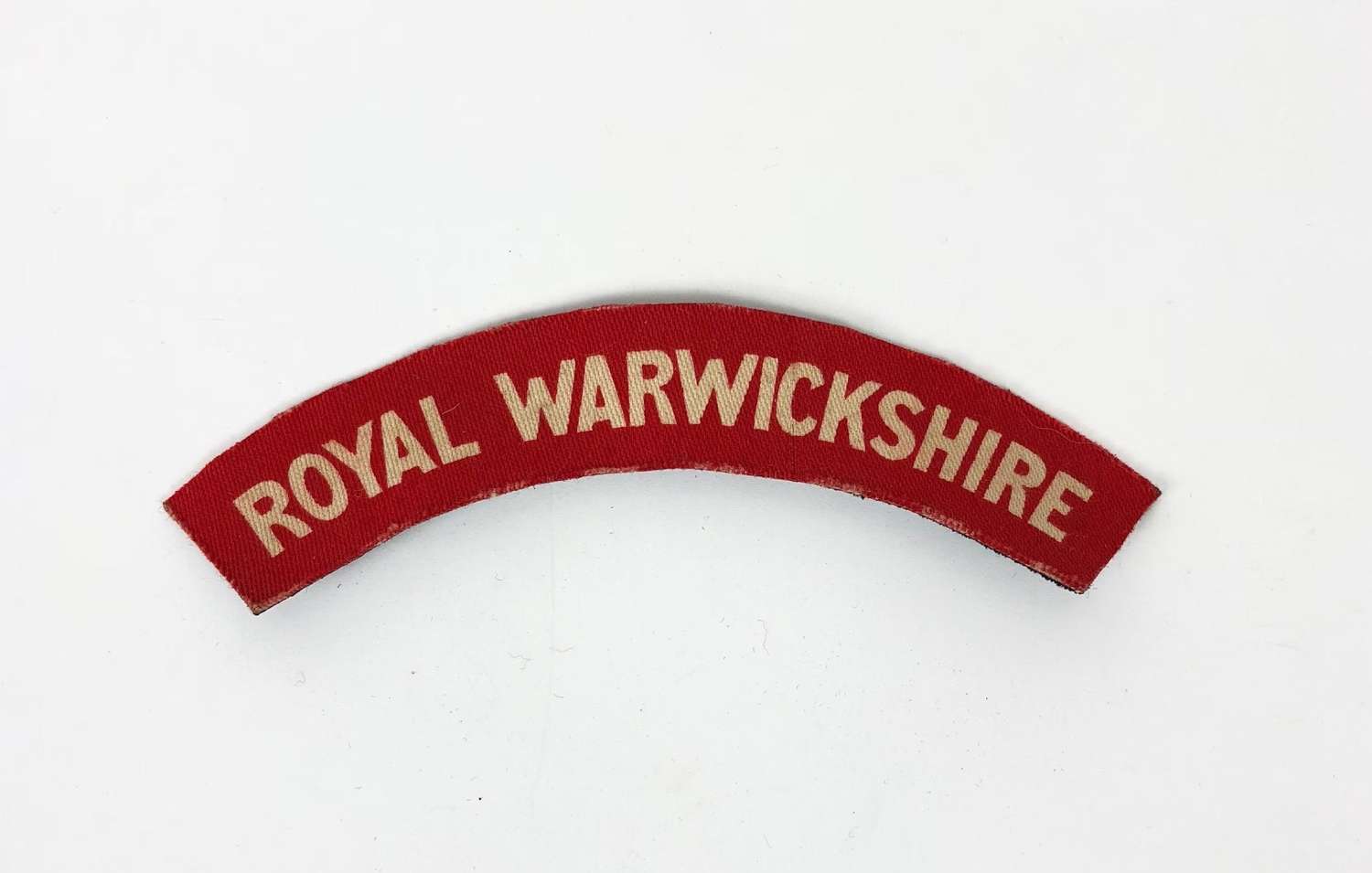 WW2 Royal Warwickshire Regiment Printed Shoulder Title Badge.